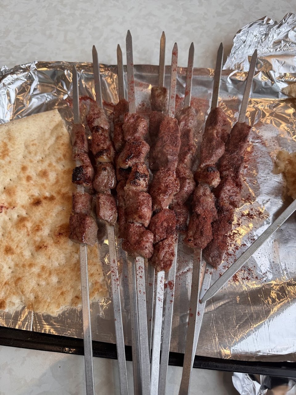Menu board with shawarma and kabob dishes.