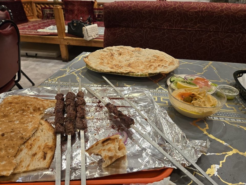 Menu board with shawarma and kabob dishes.